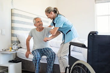 nurse-helping-old-patient-get-up-MJXB65R-scaled.jpg