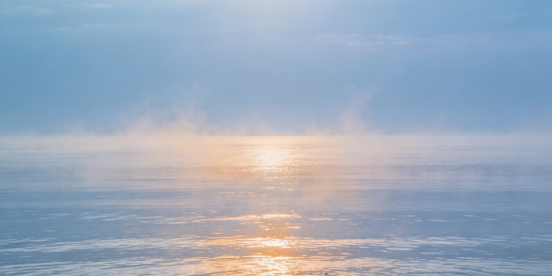 magnific__calm-ocean-horizon-under-pale-blue-morning-glassy-__14794.png