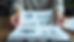 Close-up view of a person reviewing marketing strategy notes and charts