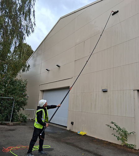 Reach‑and‑wash exterior cleaning delivering a spotless finish to the side of a commercial building.
