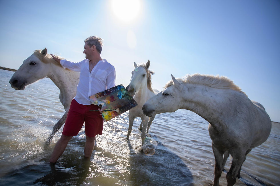 Painter Andrew Manaylo standing among horses, reflecting on 2026 – the Year of the Horse