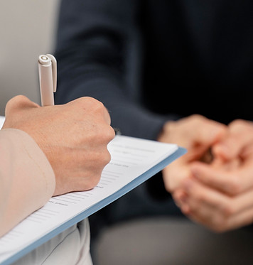 mid-shot-woman-therapist-taking-notes-clipboard.jpg