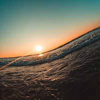 close up of ocean wave and sunset representing management of mental and emotional upheaval