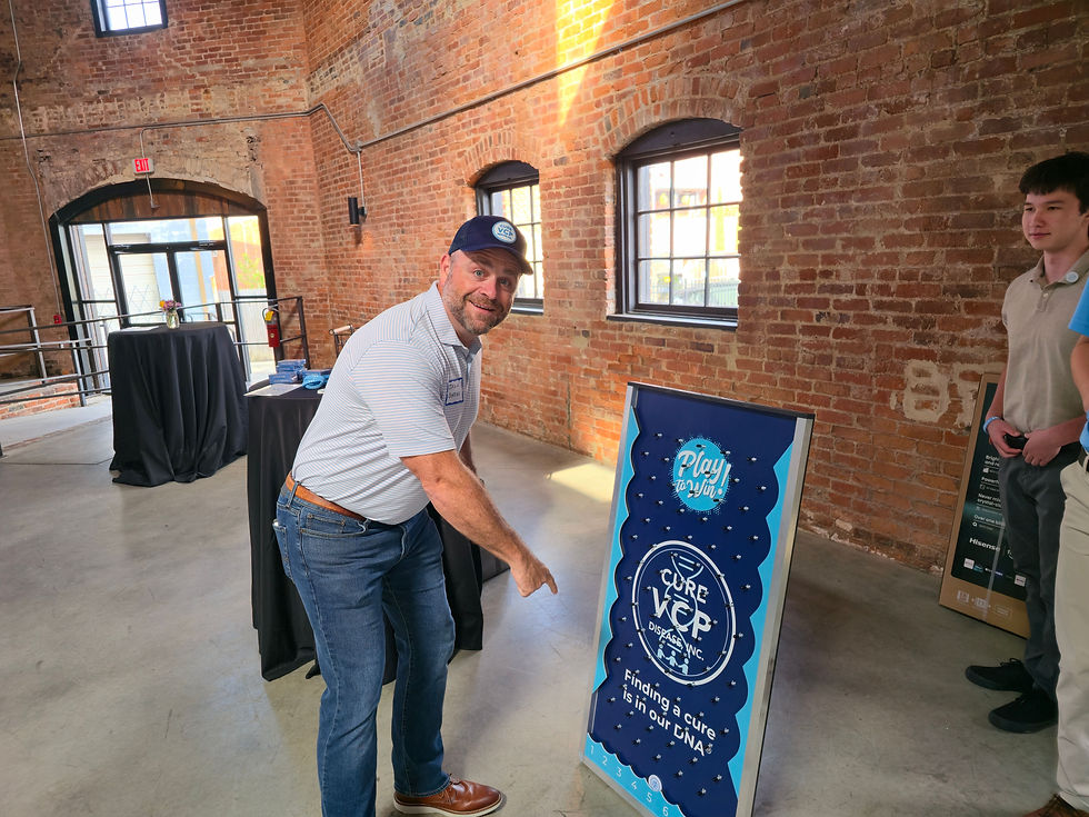 a man pointing to a Plinko board