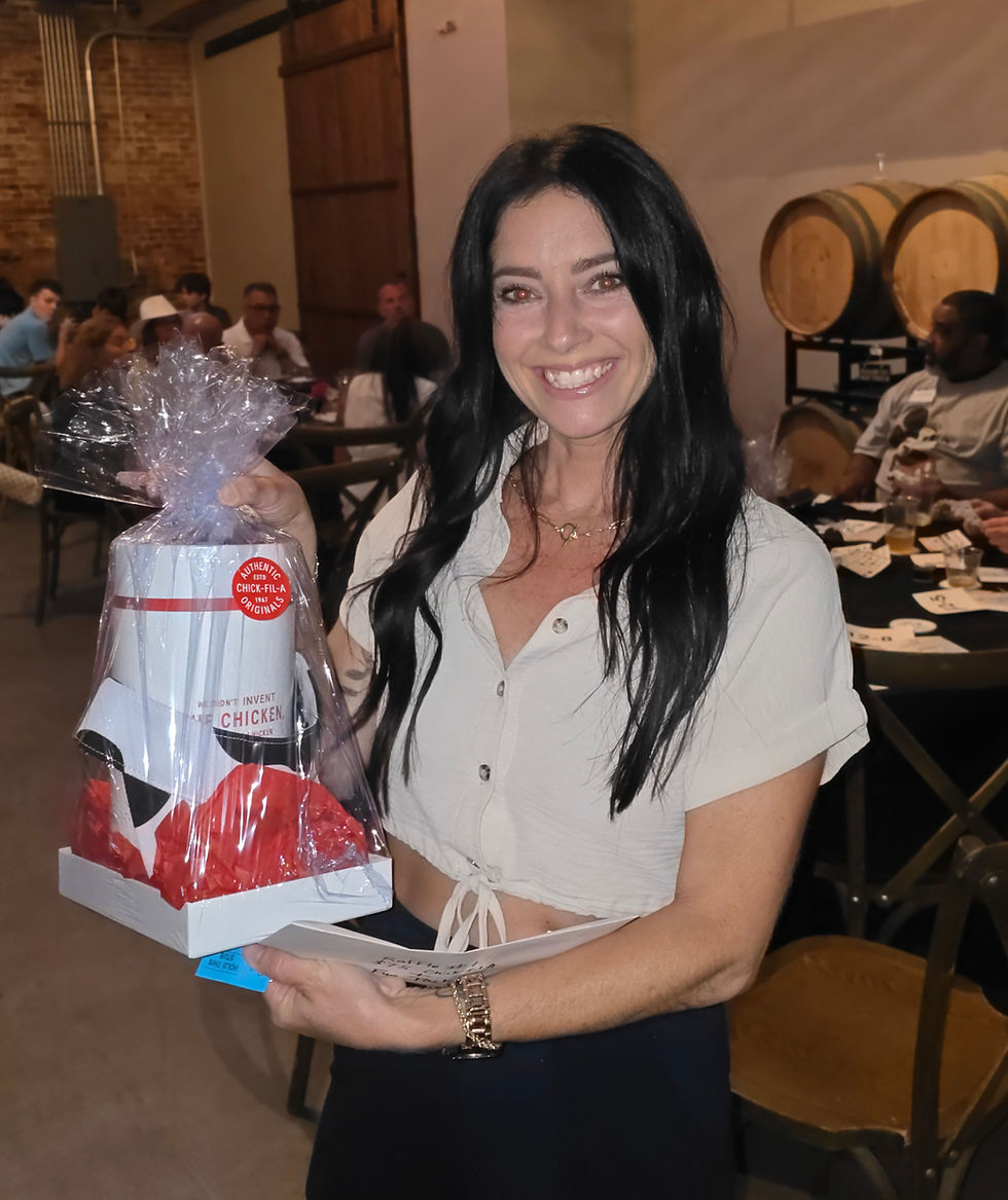 A lady in a white shirt holding a prize