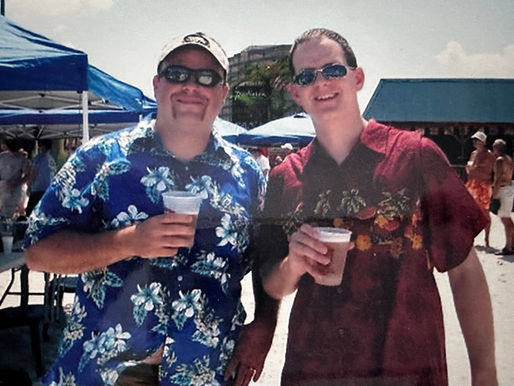two men holding a beverage