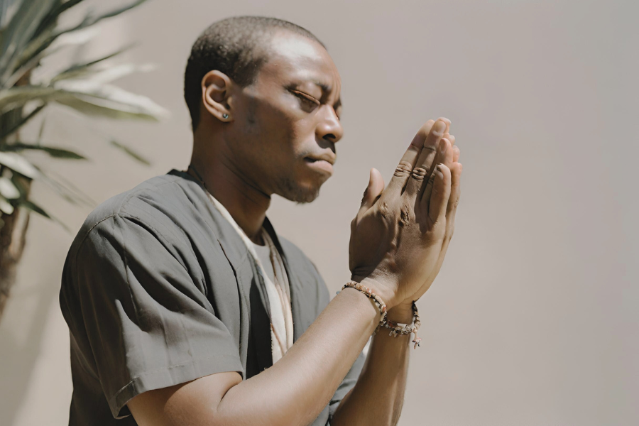 Man with hands together praying