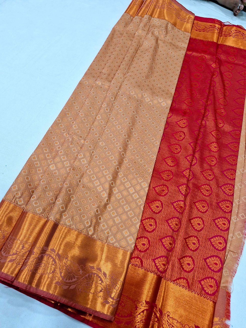 Red colour. With chocolate cream colour Kanchipuram pattu saree
