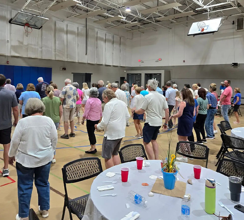 Adults in gym learning how to line dance.