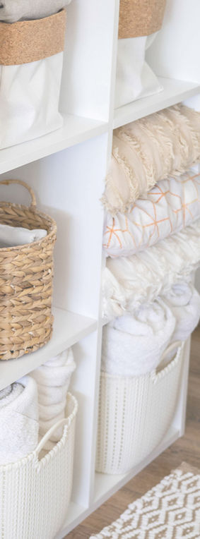 Linens folded and stored neatly on shelving.