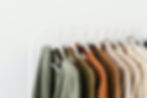Clothing beautifully organized on a rack.