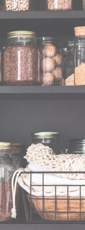 Jars of food in a kitchen cupboard.