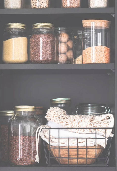 Jars of food in a kitchen cupboard.