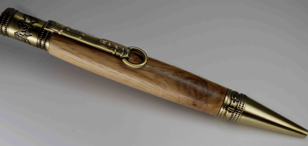 a close up of a wooden pen with a brass clasp