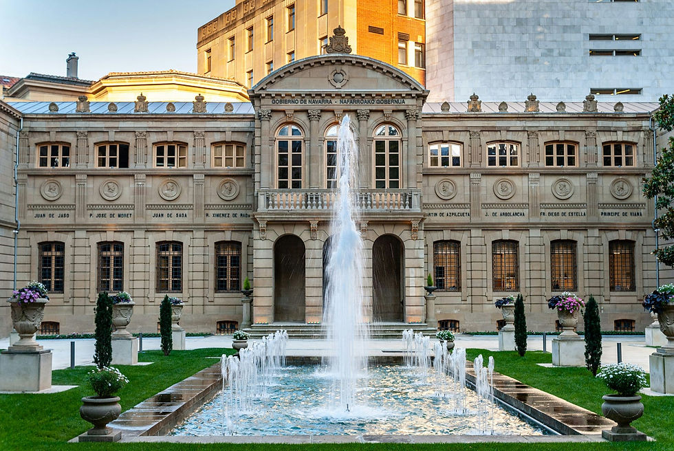 Elegant facade of the Government of Navarra building, featuring classical architecture and a serene central fountain.