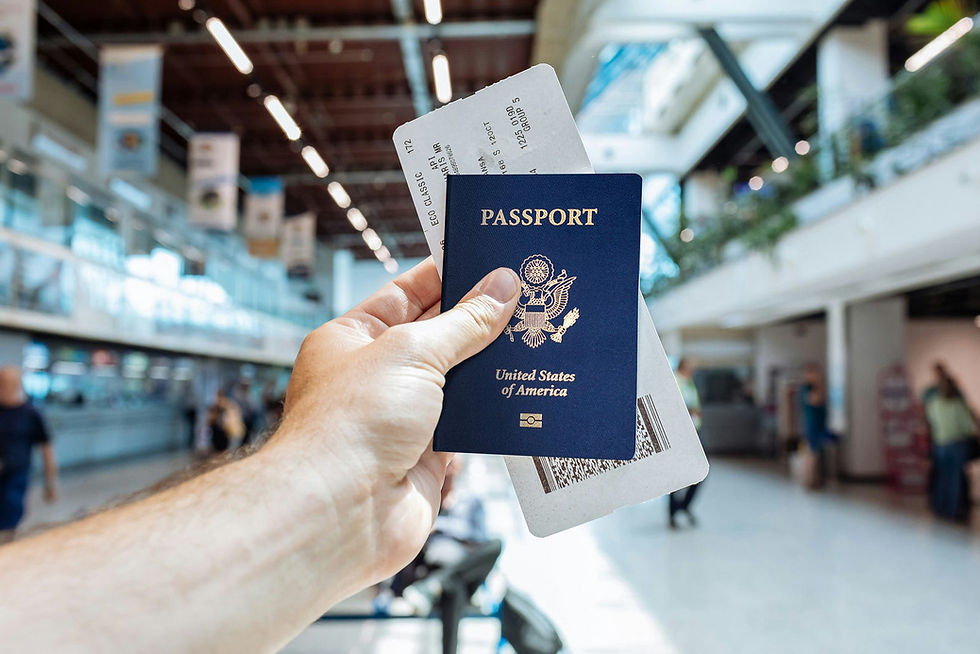 A traveler holds up their U.S. passport and boarding pass in a bustling airport terminal, ready for an upcoming flight.