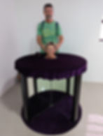 man behind a woman's head on table at Illusions