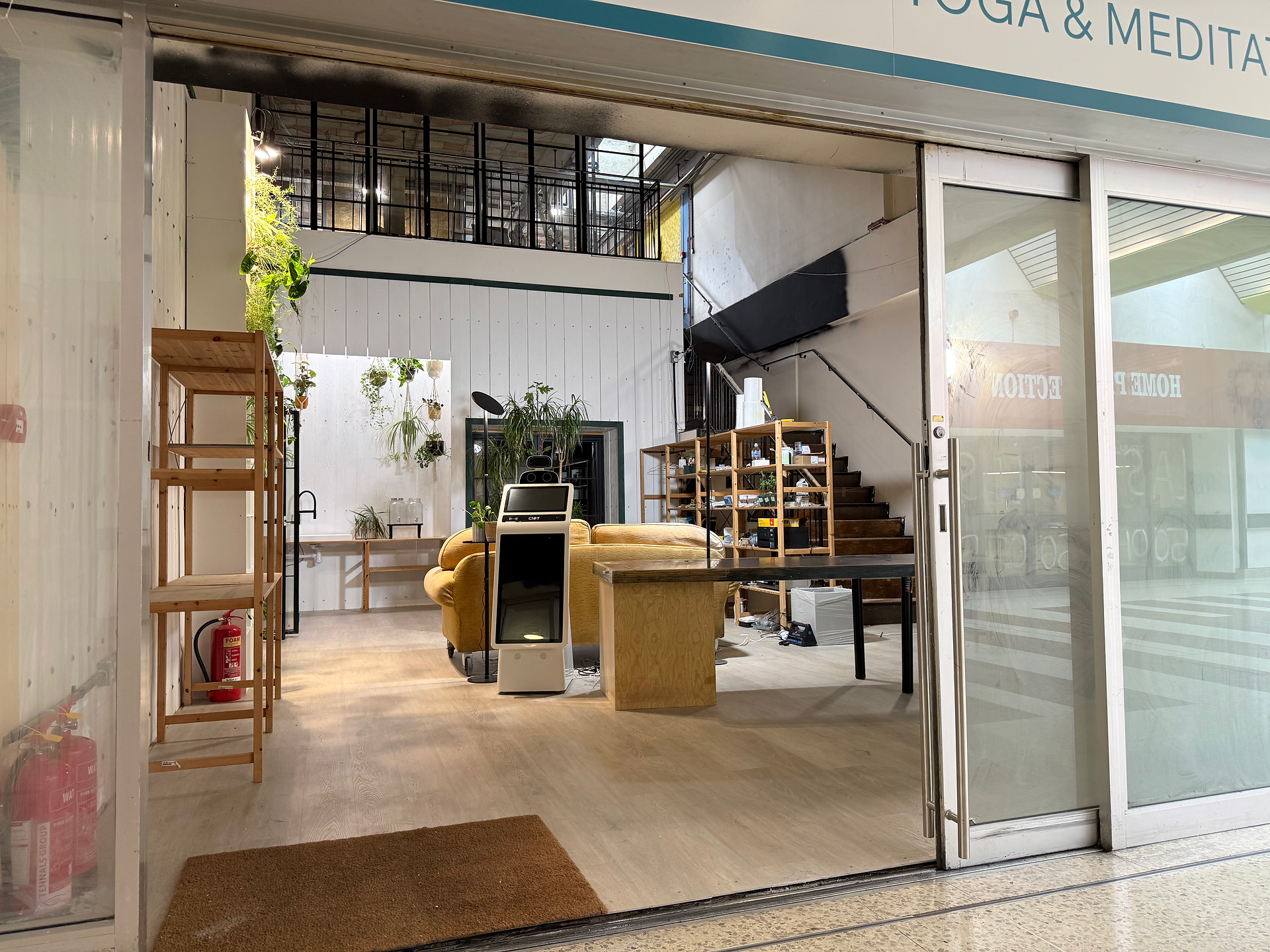 View from the shopping area to the entrance of LoveYour.Studio - Farnborough showing the receptions, shop and cafe