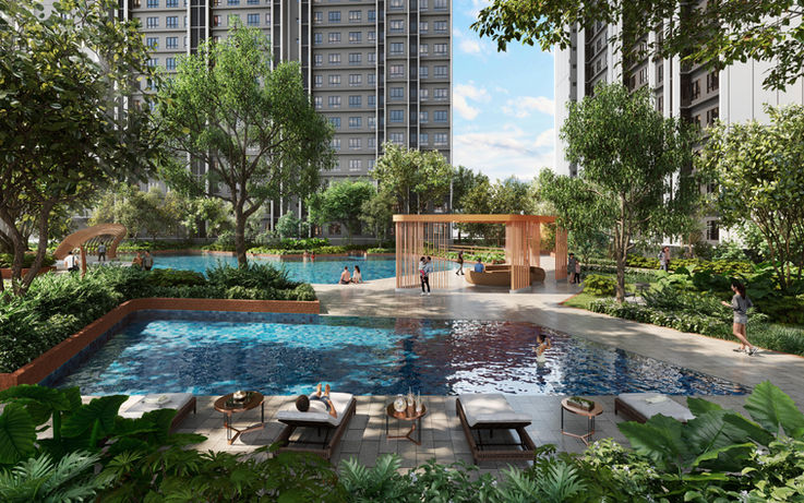 Outdoor swimming pool area with lounge chairs and modern buildings.