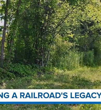 Image of a cylcistand walker on a resurfaced rail trail in West Falls, NY.