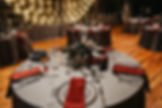 Dark moody wedding centerpiece with dried flowers gray tablecloth and red napkin