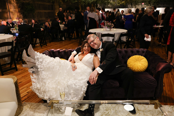 Bride and groom on wedding lounge furniture purple couch