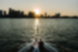 Bride and groom looking at Boston sunset from Charles River Boat wedding in Massachusetts