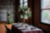 Tall wedding centerpiece round table greenery and flowers