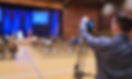 Videographer filming educational workshop
