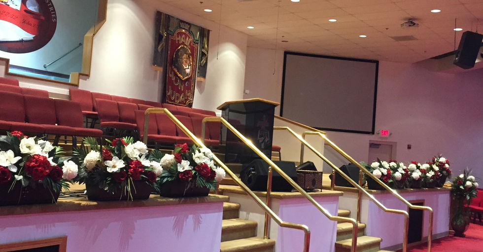 New Birth Christian Ministries sanctuary with seating, stairs, and a stage