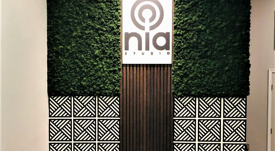 Nia Studios lobby with live plant wall and company logo