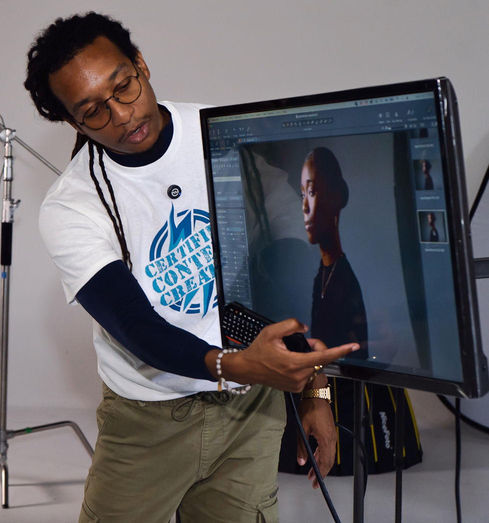 Mentor Jik-Reuben Pringle demonstrating lighting techniques to Spark Series students, showing how light transforms photography at Camera TechSource in Kingston, Jamaica.
