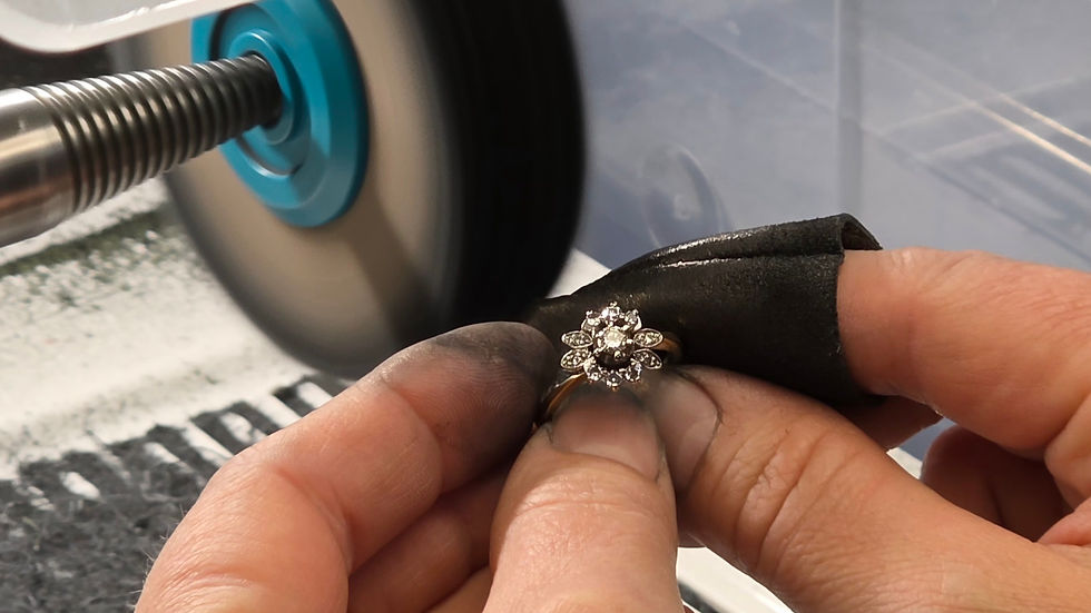 High angle view of a jeweller polishing a custom gold necklace