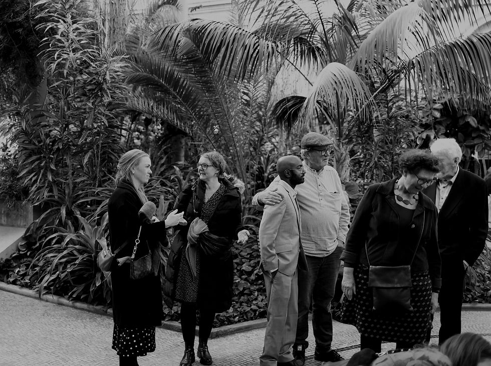 People gathered in a lush botanical garden with tropical plants._edited.jpg