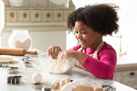 Adorable Little Black Girl Kneading Dough For Cookies, Having Fun In Kitchen Interior. Cut