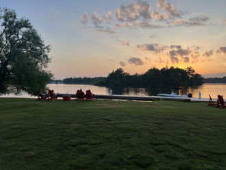 People enjoying the sunset by the water