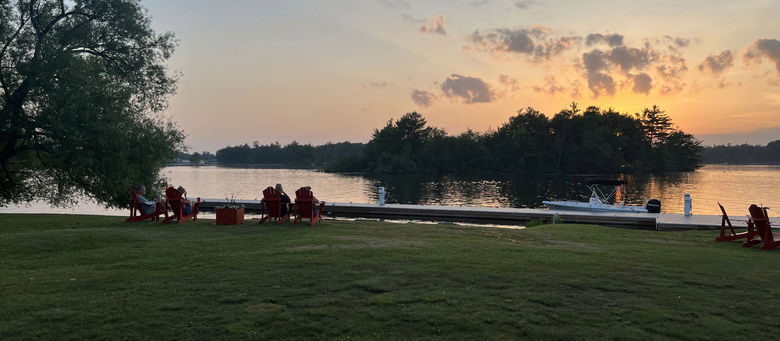 People enjoying the sunset by the water