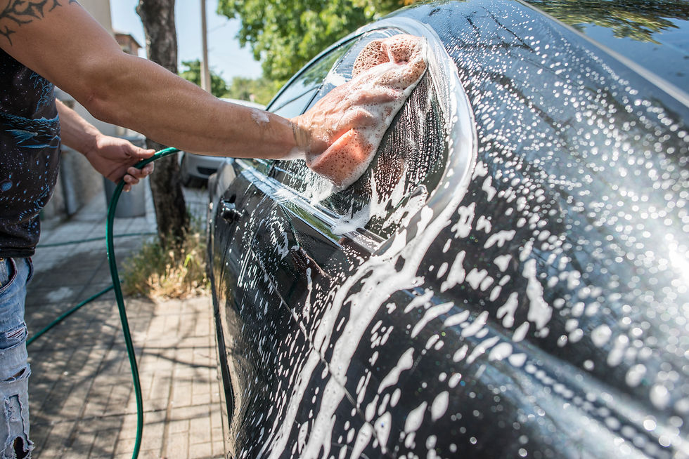 adult-man-washing-car-with-water-and-sponge-2026-03-09-05-23-19-utc.jpg