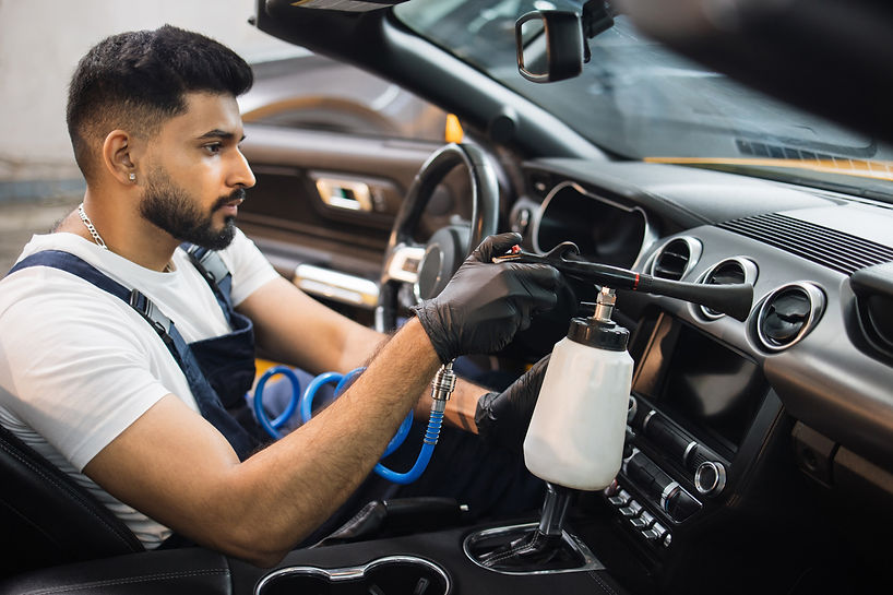 man-cleaning-car-interior-with-air-pressure-tool-2026-01-06-10-22-40-utc.jpg