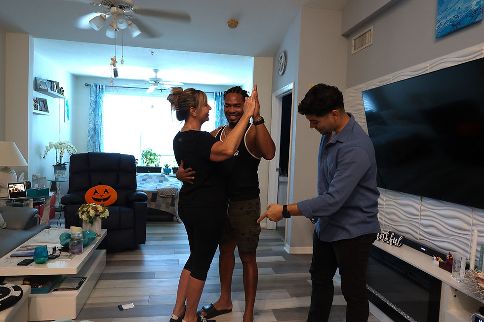 Couple learning their first dance during a private at home wedding dance lesson in Sarasota FL with instructor guidance