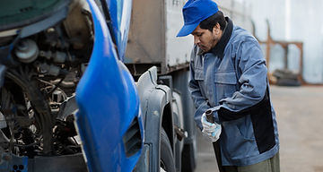 full-shot-mechanic-checking-truck.jpg