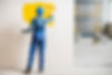 construction-worker-paints-interior-wall-yellow-wi-2026-03-24-00-20-03-utc.jpg