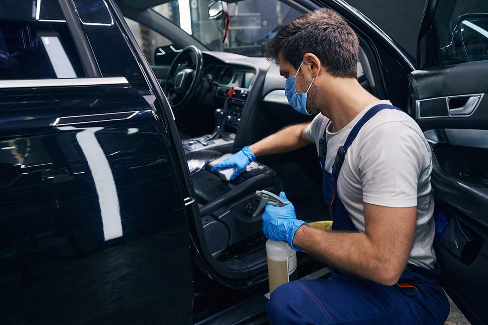 male-wiping-seat-clean-in-black-car-during-detailing-1536x1024.jpg