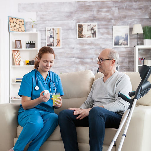 pretty-young-nurse-in-nursing-home-giving-medication.jpg