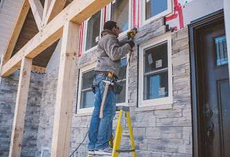 construction-worker-installing-stone-facade-on-new-2026-03-25-01-27-54-utc.jpg