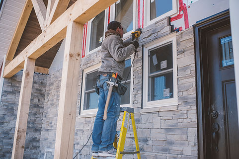 construction-worker-installing-stone-facade-on-new-2026-03-25-01-27-54-utc.jpg