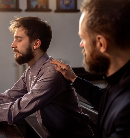 close-up-priest-talking-with-person.jpg