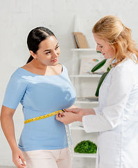 attractive-nutritionist-measuring-body-of-patient-2026-01-06-00-43-08-utc.jpg
