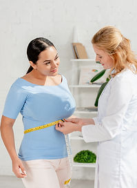 attractive-nutritionist-measuring-body-of-patient-2026-01-06-00-43-08-utc.jpg