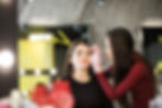 two-girls-are-doing-make-up-front-big-mirror.jpg